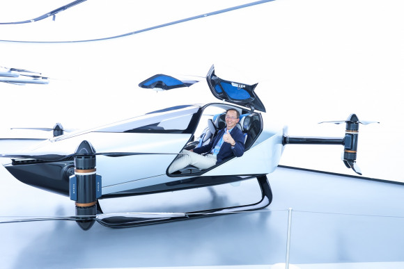 Professor William K.M. Lee, Director, test-riding XPeng's flying vehicle 